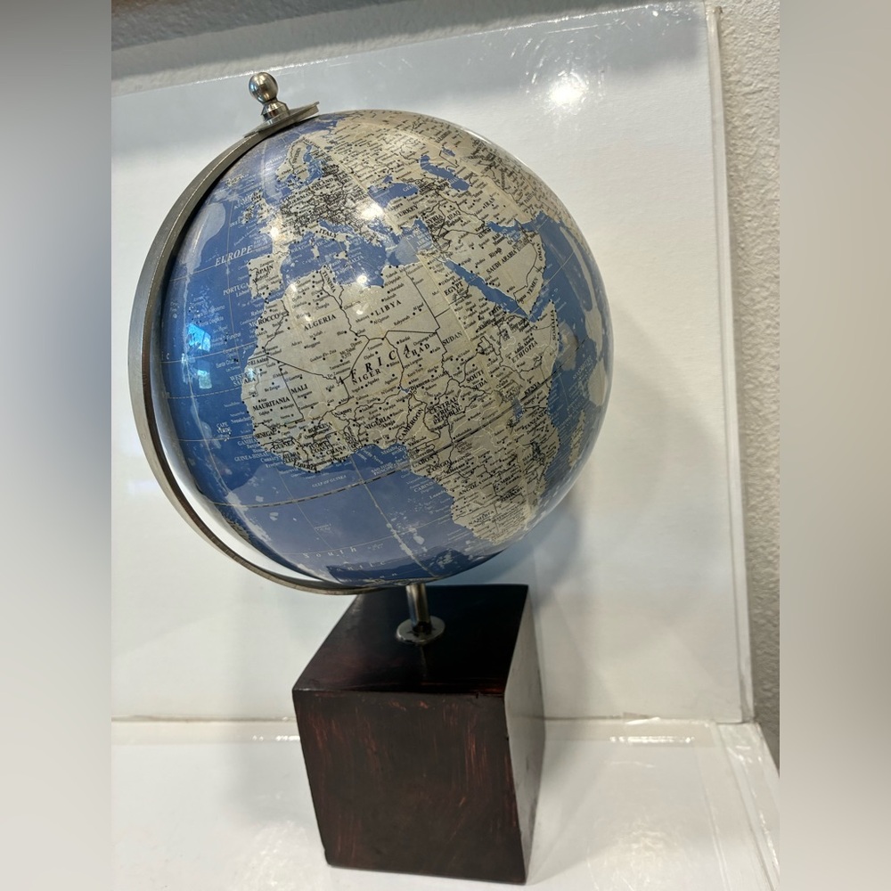 Blue and Silver Globe on Wooden Base